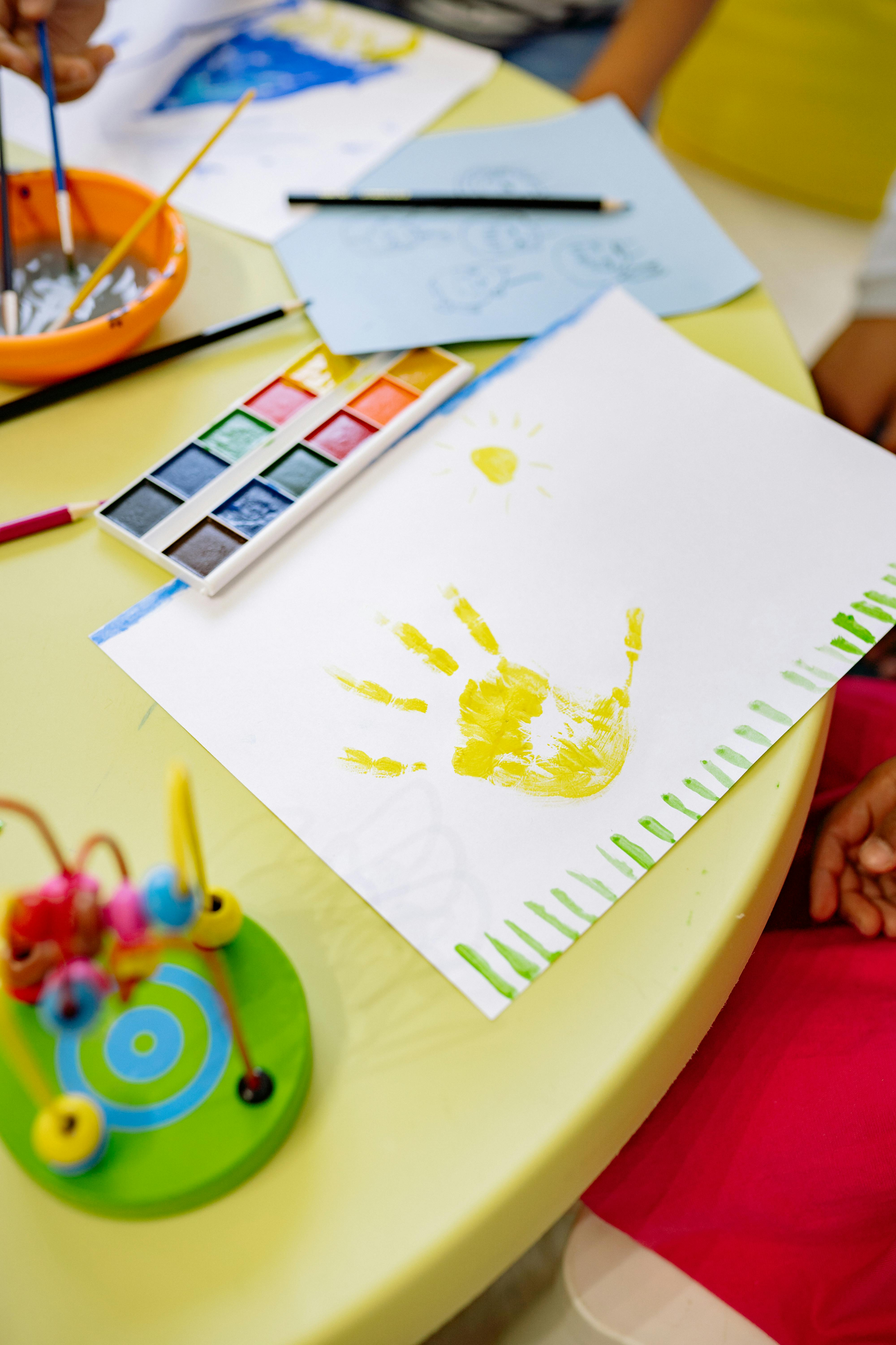 art materials and painting of a hand on table