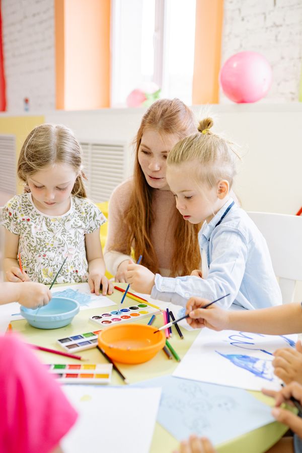 Preschool children painting with watercolours