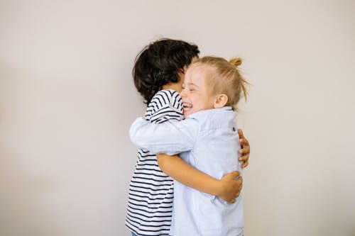 A Boy and Blonde Girl Hugging Each Other