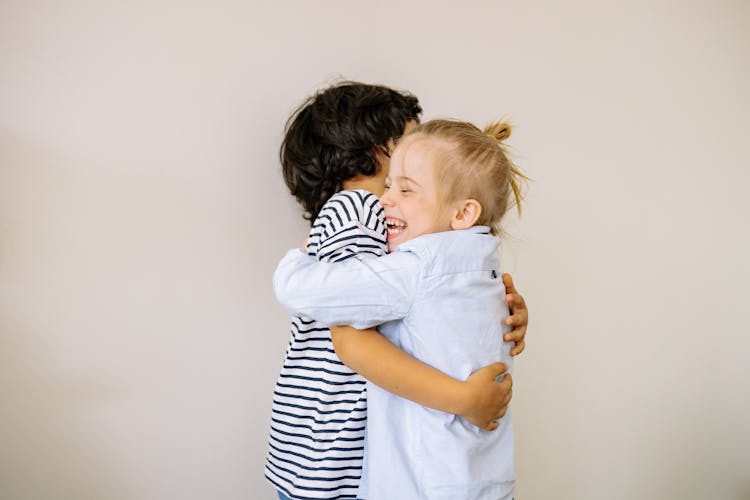 A Boy And Blonde Girl Hugging Each Other