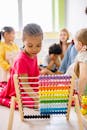 Girl In Red Dress Playing With An Abacus