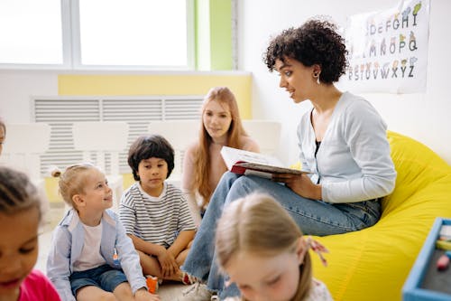 Woman Reading A Book To The Children