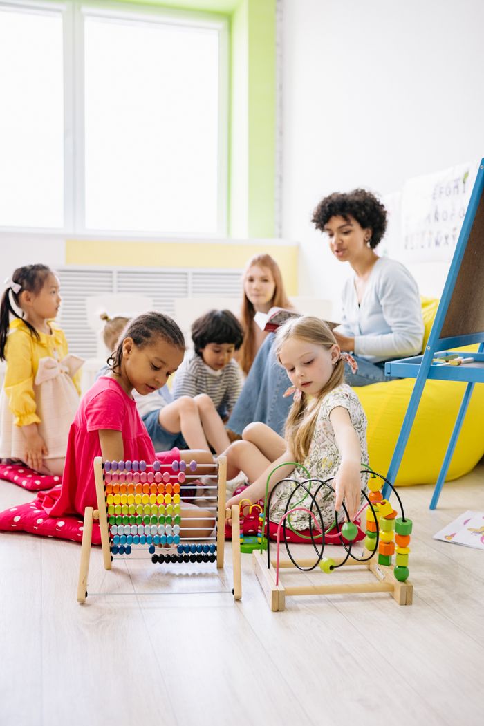 Group of children learning together with abacus tools