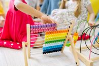 Girl Holding Multi Colored Wooden Abacus