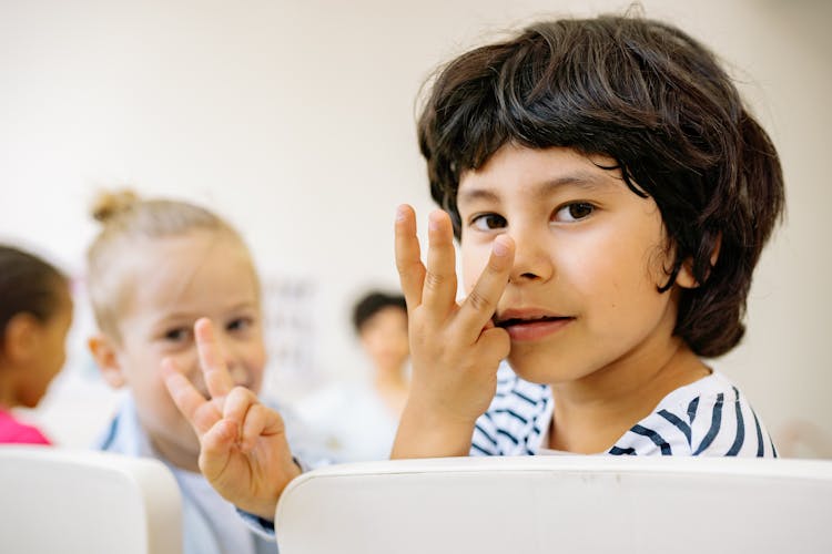 Boy And Girl Counting With Their Fingers