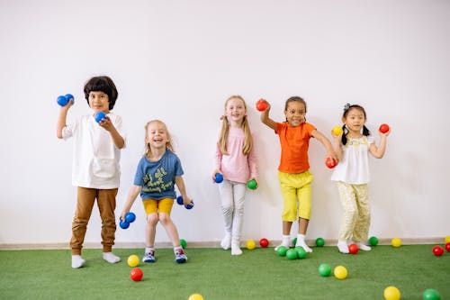 Free Little Girls and Boys Having Fun Playing With Colorful Balls Stock Photo