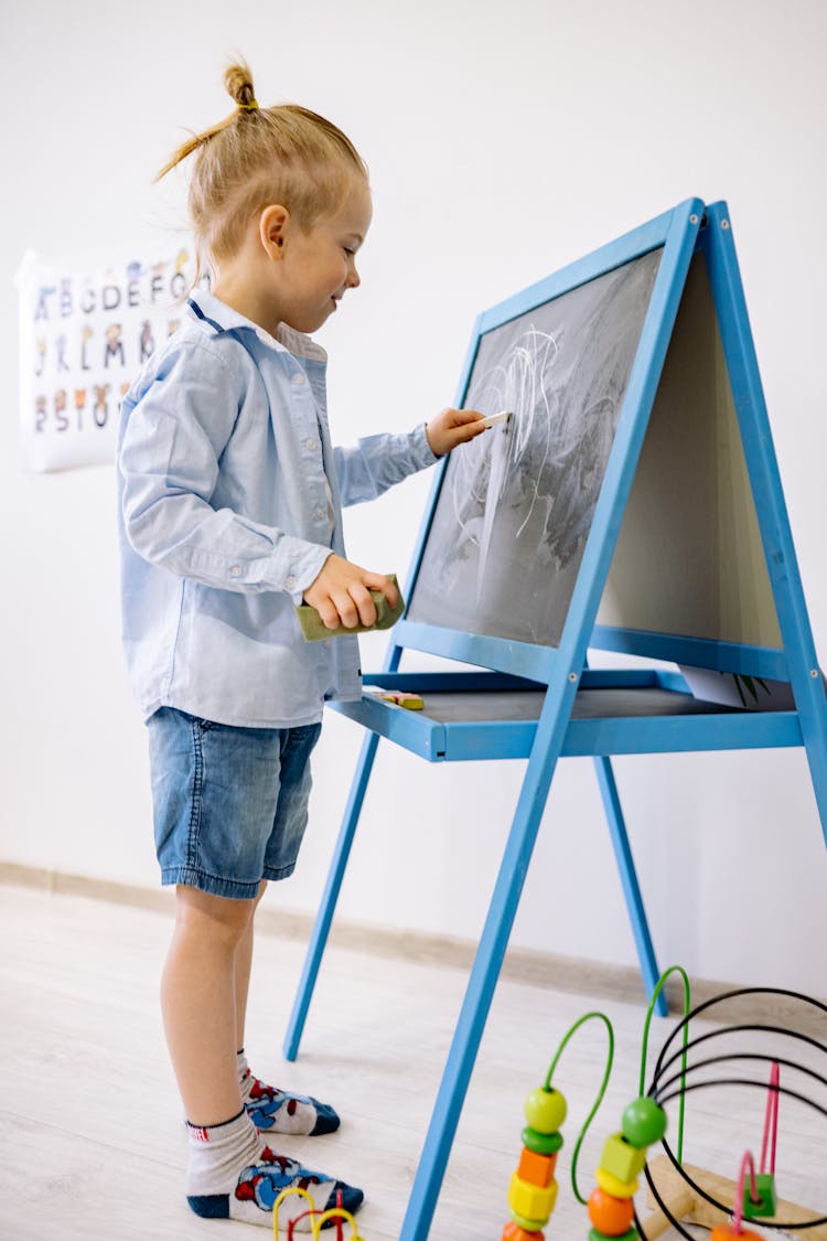 Boy Writing On A Blackboard