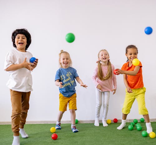 Free Happy Children Playing With Colorful Plastic Balls Stock Photo