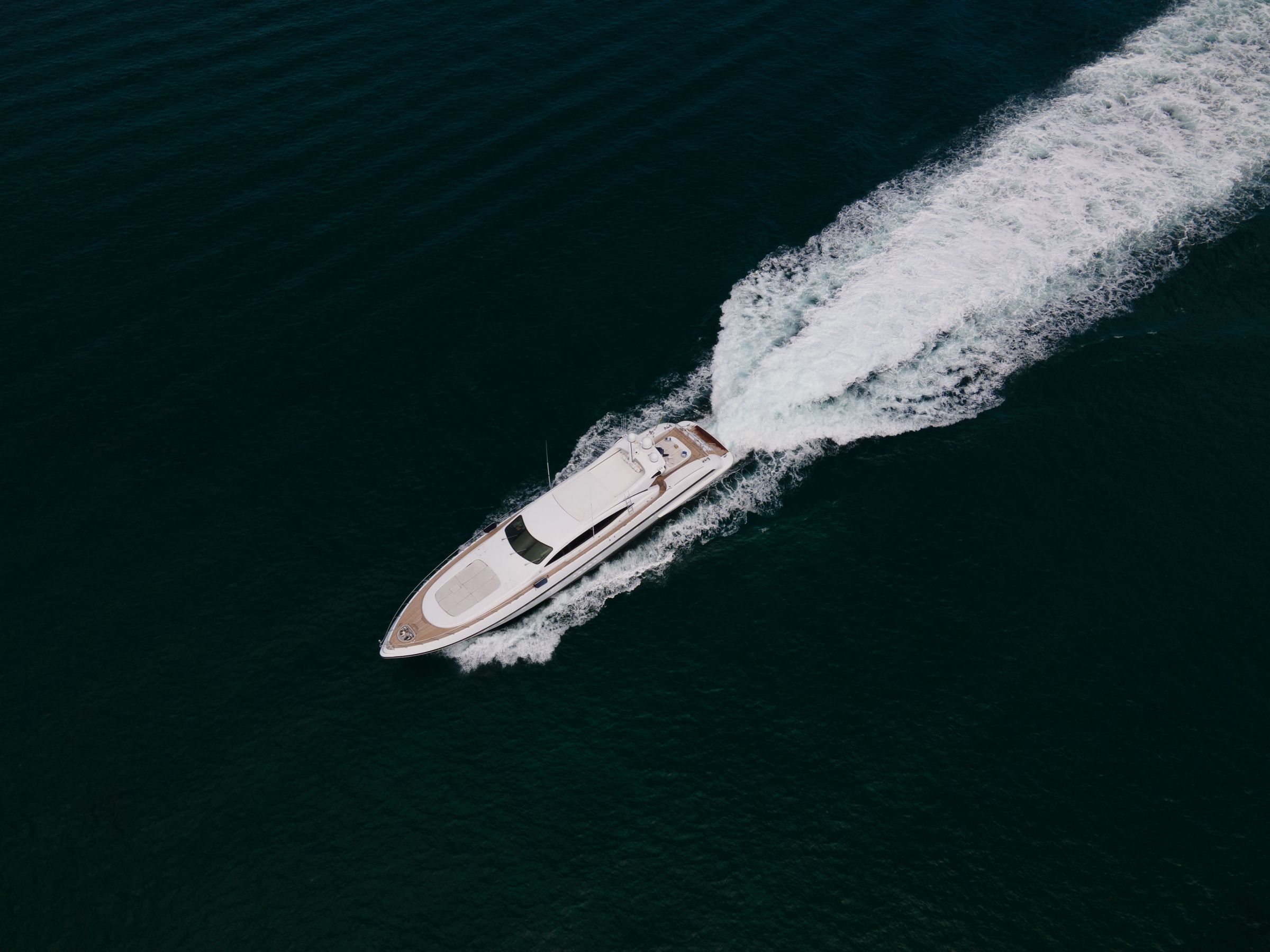 A boat cutting across deep blue water