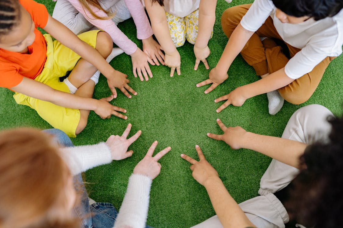 Group of Children Playing on Green Grass 