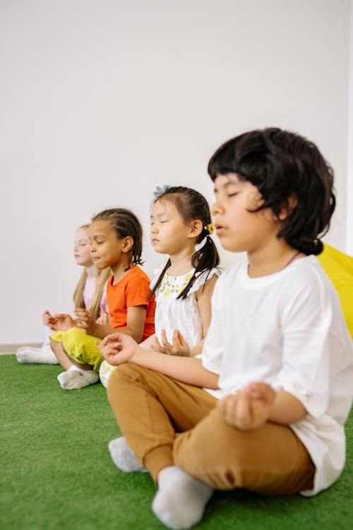 Children In Yoga Position Learning To Concentrate