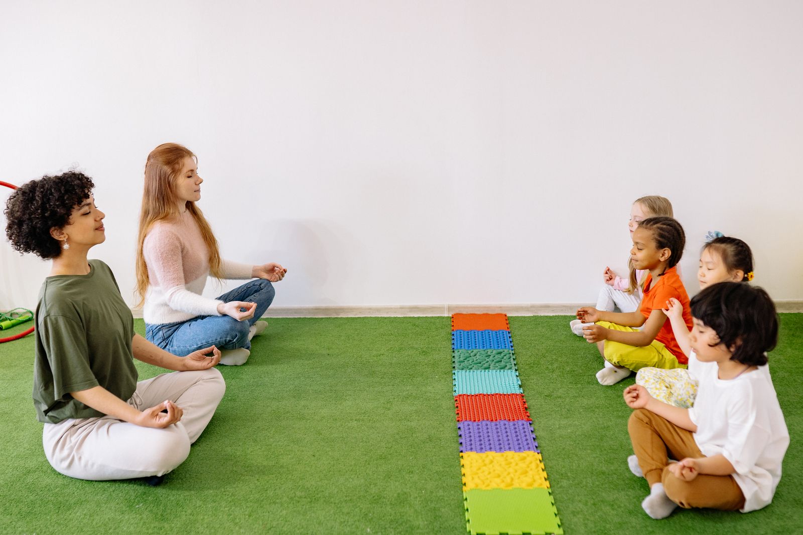 Group of kids practicing yoga poses together in a preschool mindfulness session