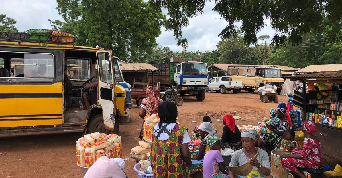 Street food vendor in Ho, Ghana selling modernized traditional snacks to young customers