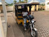 Man in Black Jacket Riding Yellow and Black Auto Rickshaw
