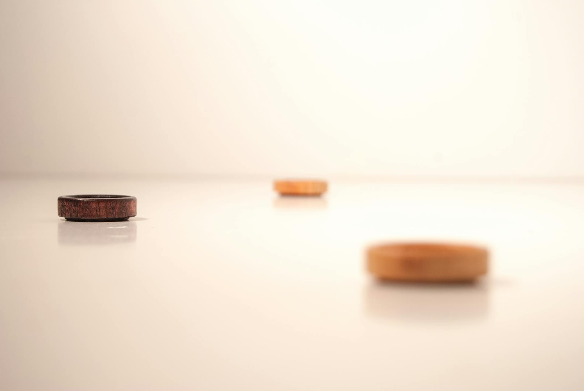 A minimalist photo featuring cork lids on a white surface, creating a serene and neutral aesthetic.