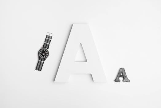 Minimalist layout featuring typography with a sleek watch and bold letter A design.