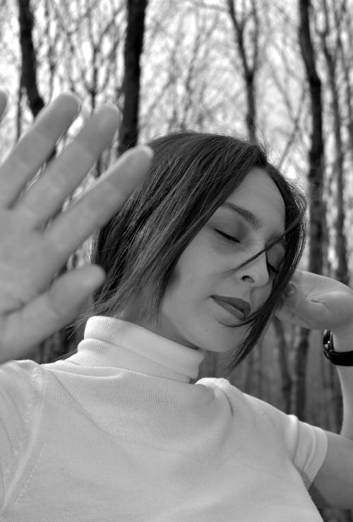 Grayscale Photo of Woman in White Shirt