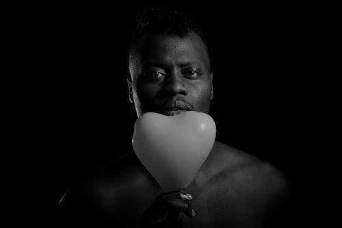 Free Man Holding a Heart Shaped Balloon Stock Photo