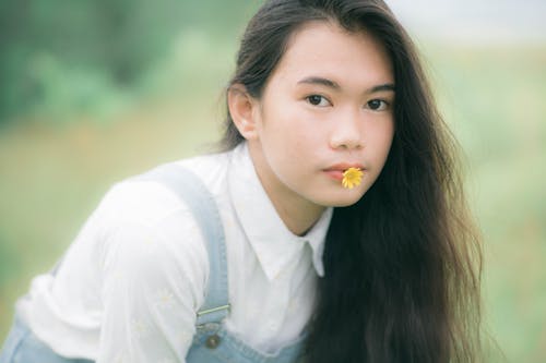 Teenage Girl with Flower on her Lip