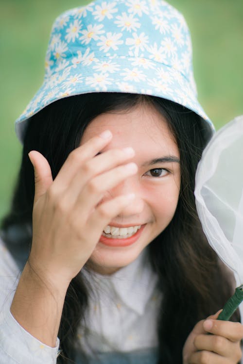 Smiling Girl Wearing a Bucket Hat