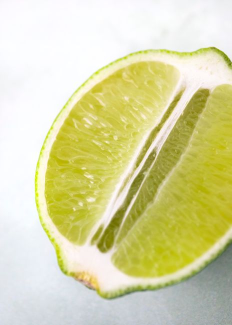 Vibrant close-up of a juicy lime half showcasing its fresh and tangy texture.