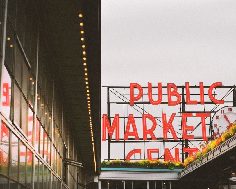 View of the iconic Public Market Center sign in Seattle, showcasing vibrant neon lights.