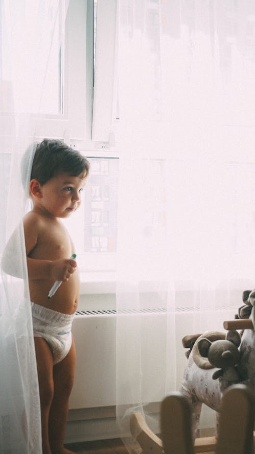 Toddler Standing Near Window