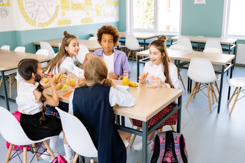 Free Students Eating Their Snacks at the School Canteen Stock Photo