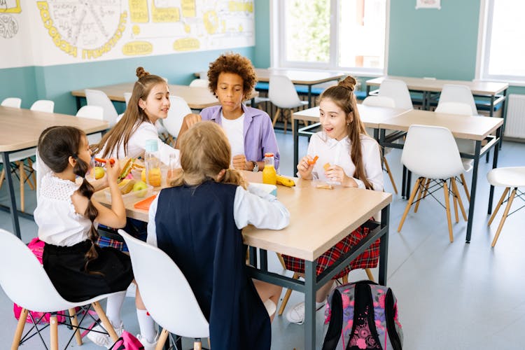 Students Eating Their Snacks At The School Canteen