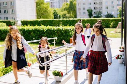 Joyful group of kids heading to school on a sunny day, ready to learn and have fun together.