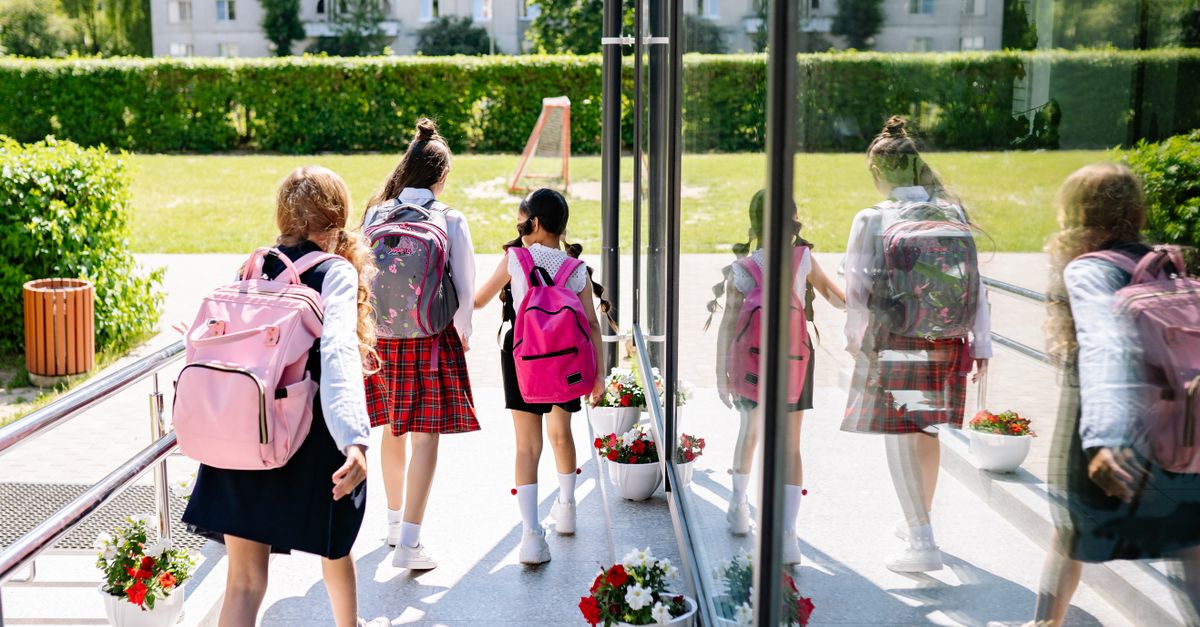 elementary school students walking home with backpacks no homework sign