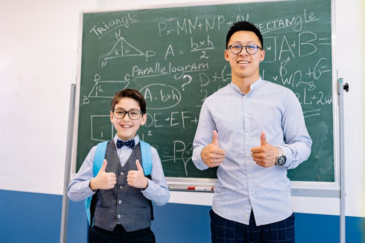 A Teacher And A Student Doing A Thumbs Up