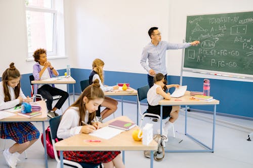Free Male Teacher Discussing His Lesson About Mathematics Stock Photo
