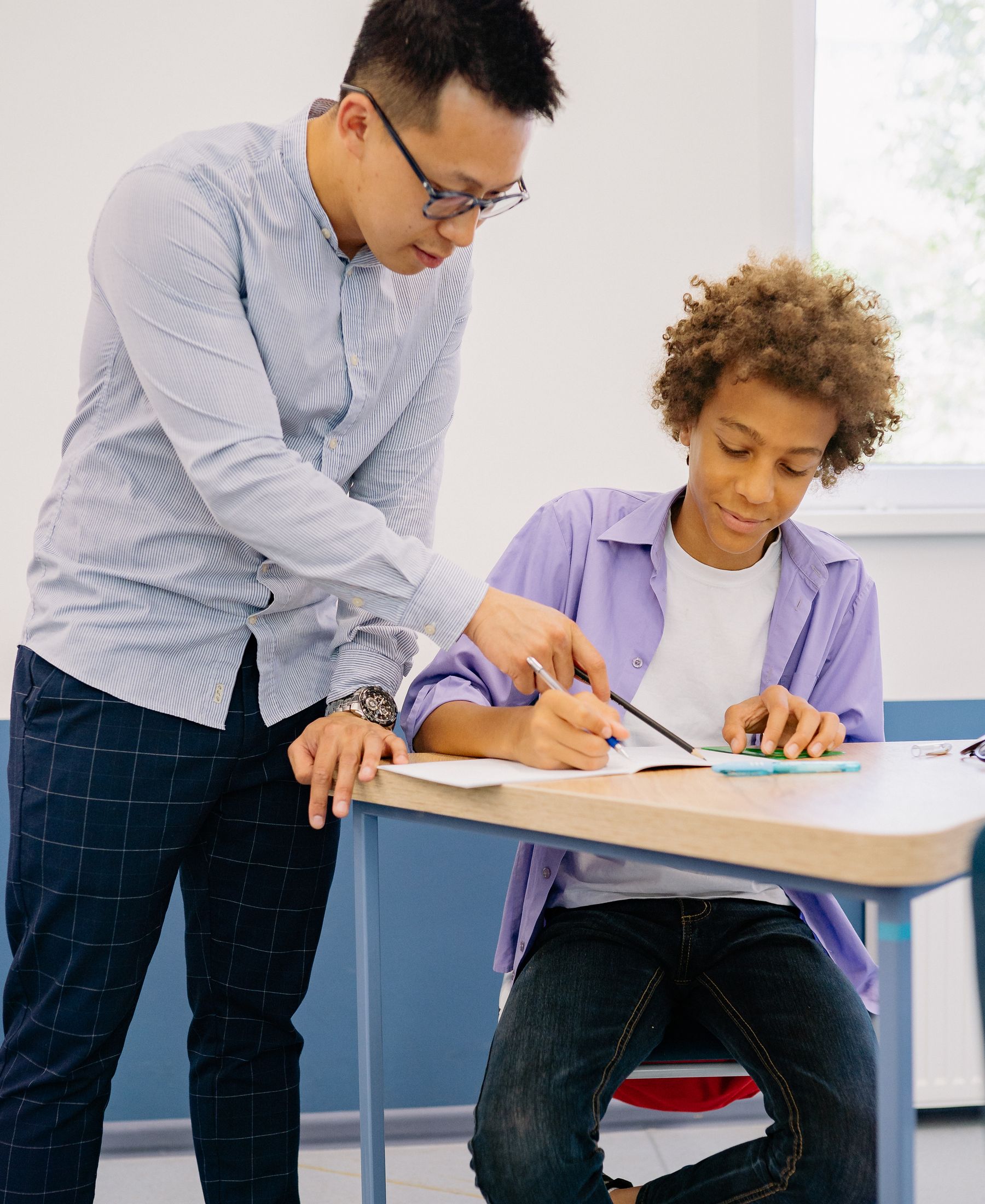 A mentor guiding a young man — every nationality welcome