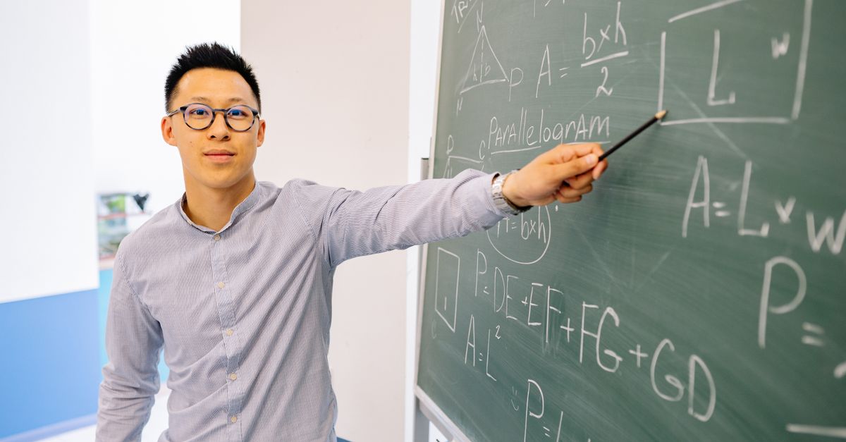 A pastor in a suit pointing at a chalkboard filled with complex equations and Bible verses