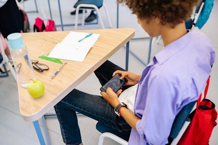  Boy Playing On His Phone