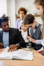 A Boy Using a Microscope beside His Teacher