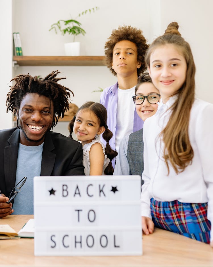 Teacher With His Students Posing Together