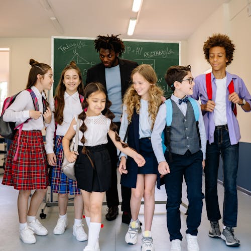 Children Walking at the School with Their Teacher