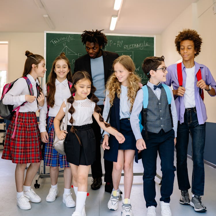 Children Walking At The School With Their Teacher