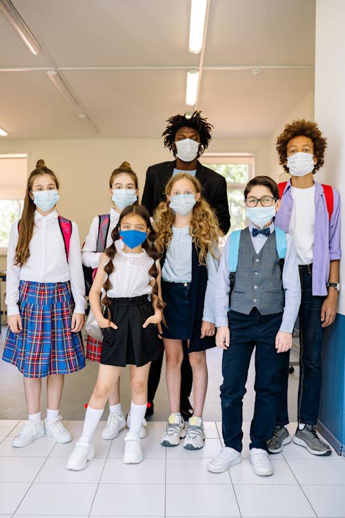 Free A Teacher and Students Wearing Face Masks Stock Photo