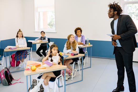 Students attentively listening to a teacher in a modern classroom setting.