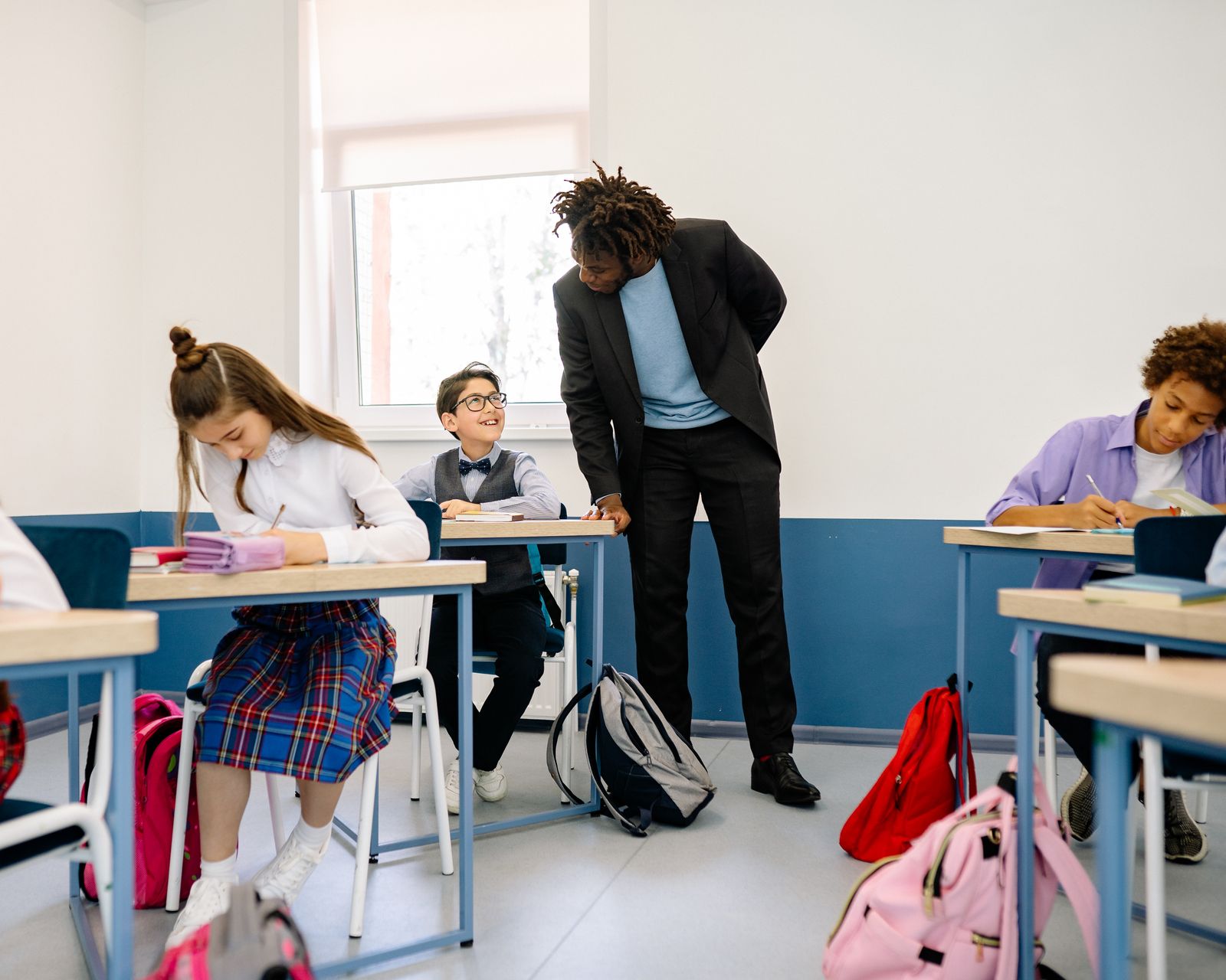 Teacher supporting students in a classroom