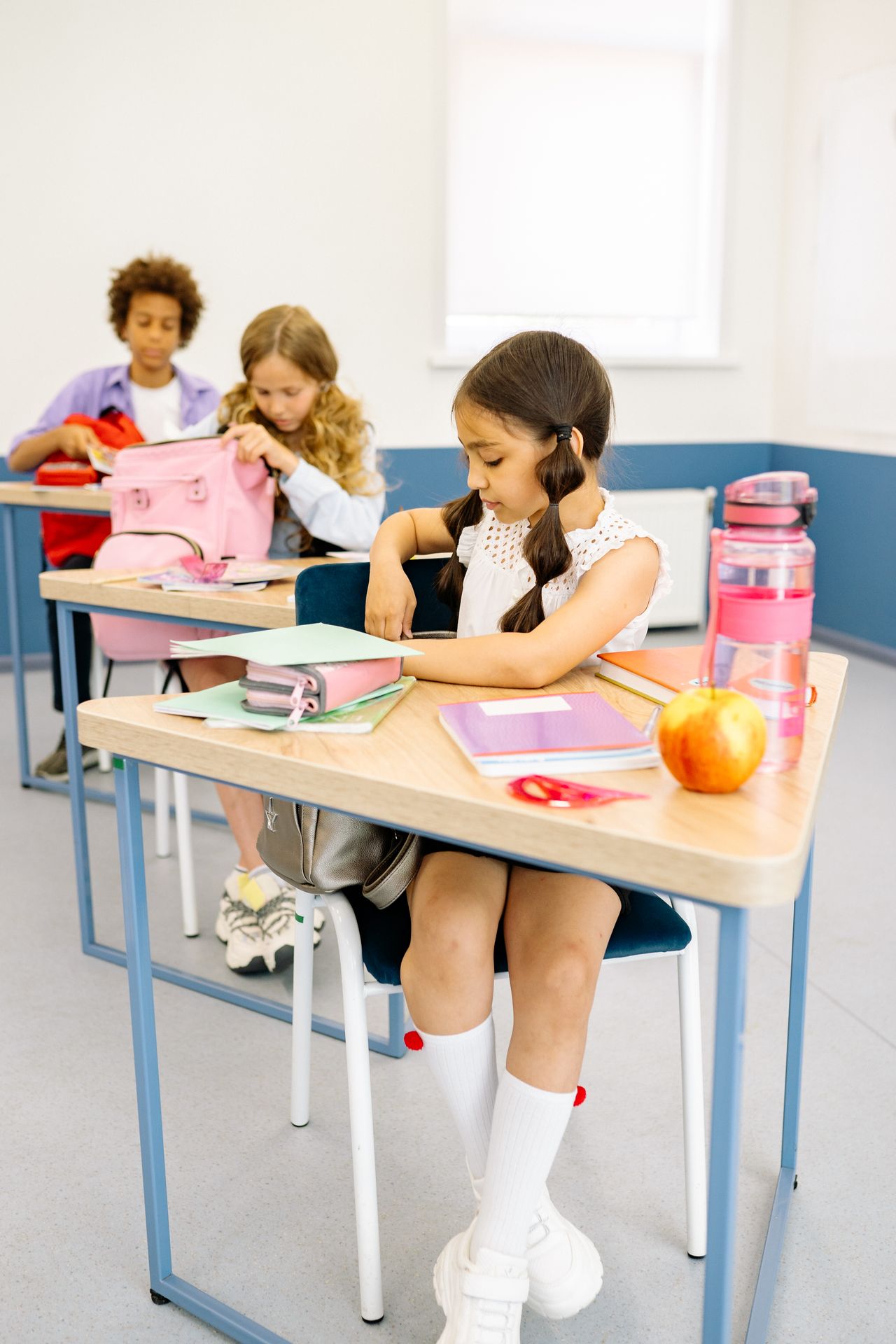 classroom-gallery-modern Young students seated at desks in a bright modern classroom
