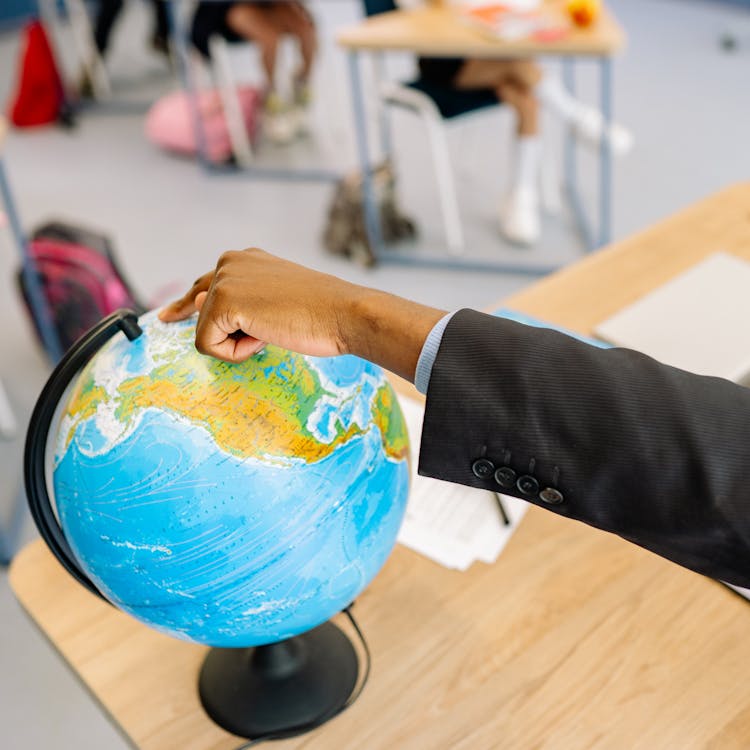 Man Pointing To Globe