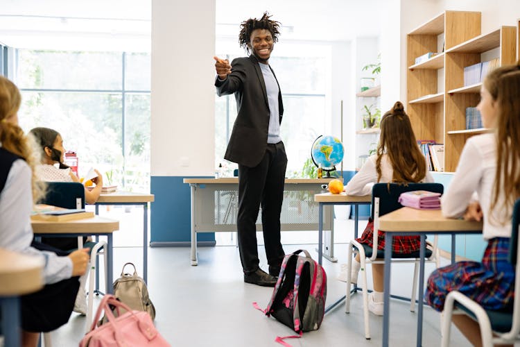 Teacher Smiling With His Students