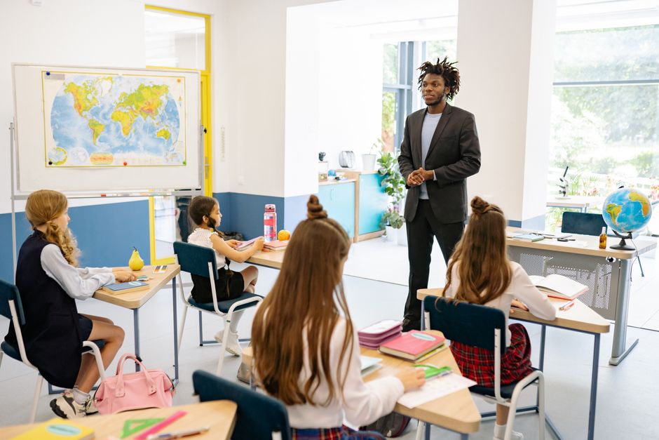 Educator teaching students in a classroom Educator teaching students in a classroom