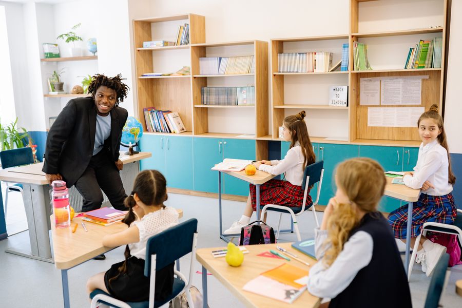 Teacher with students in a bright classroom