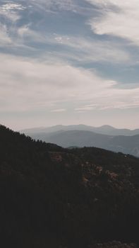 Tranquil view of distant mountains under a cloudy sky, perfect for nature lovers.