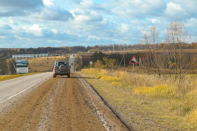 Car Driving On A Road With Dirt